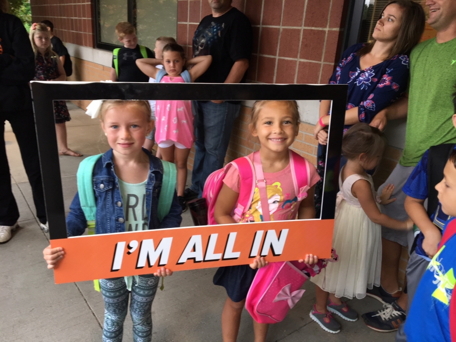 people holding a frame sign